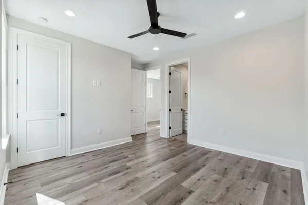 a view of an empty room with wooden floor
