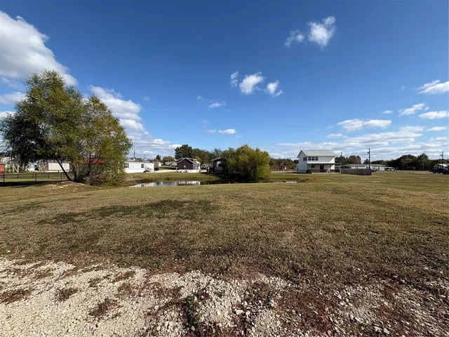a view of a lake with houses in the background