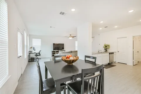 a view of a dining room with furniture and a window