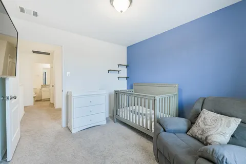 a bedroom with furniture and a rug