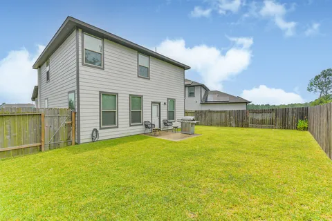 a view of a house with pool and a yard