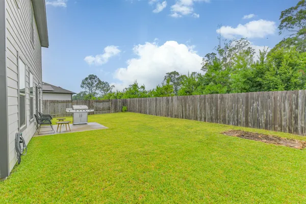 a view of yard with swimming pool and seating space