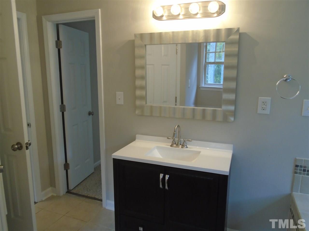 3241 Banks Road Raleigh, NC 27603 - Photo 11 of 19 a bathroom with a sink and a mirror