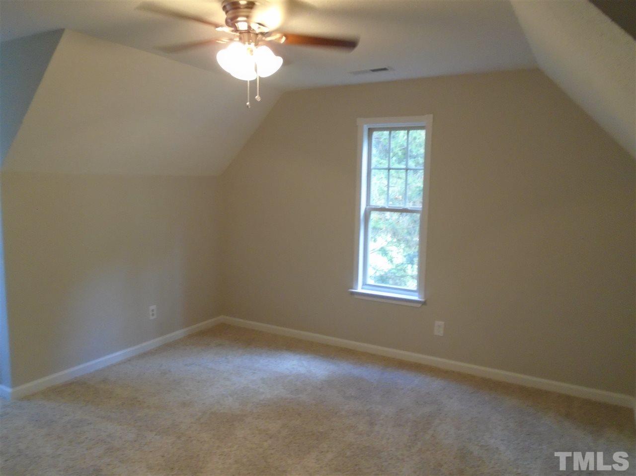3241 Banks Road Raleigh, NC 27603 - Photo 18 of 19 an empty room with a window and a chandelier fan