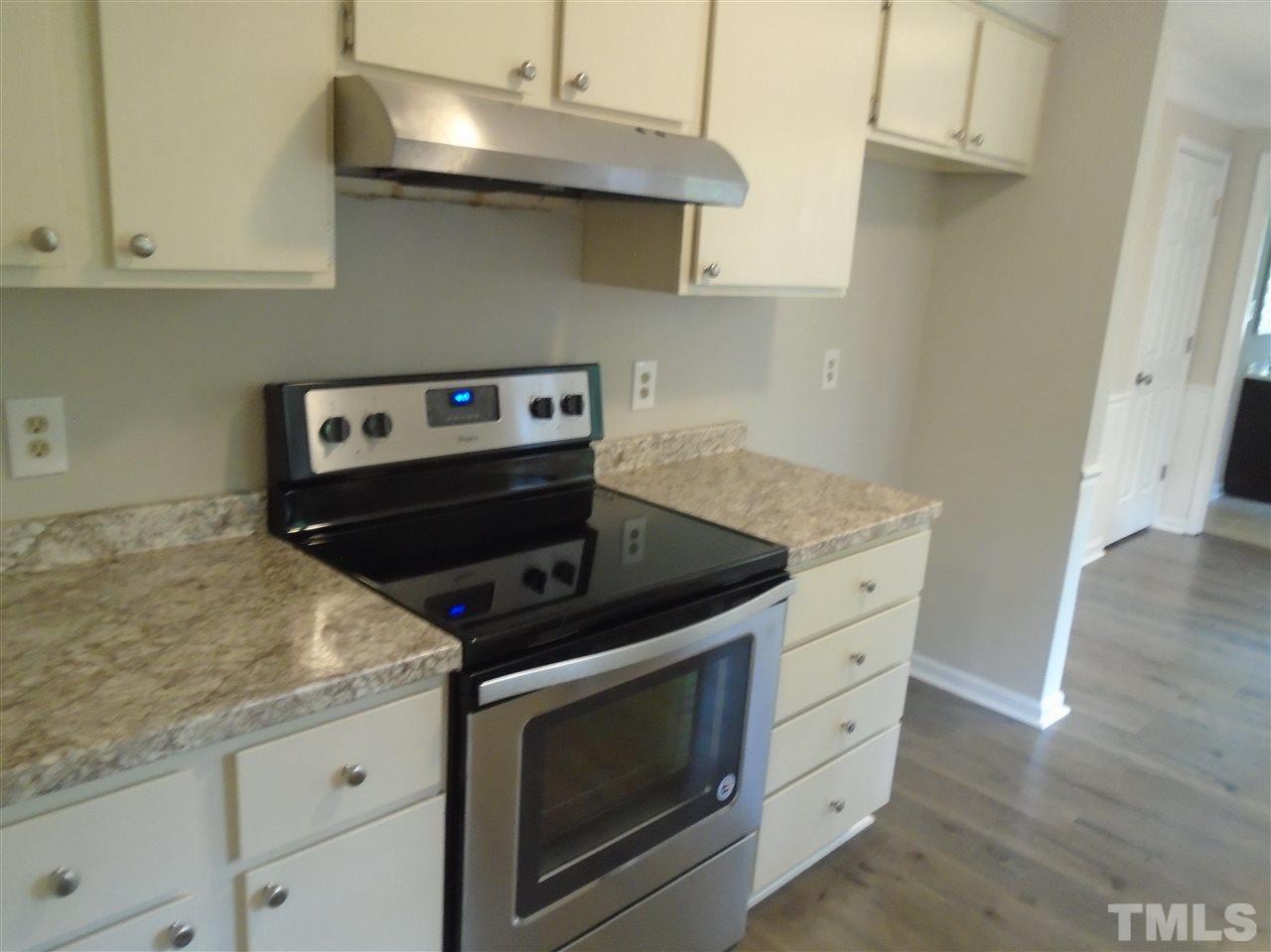 3241 Banks Road Raleigh, NC 27603 - Photo 6 of 19 a stove top oven sitting inside of a kitchen