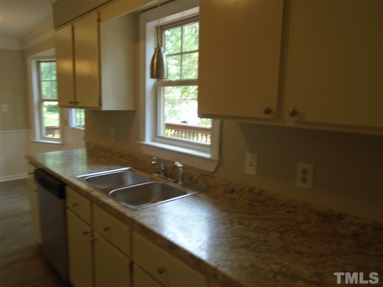 3241 Banks Road Raleigh, NC 27603 - Photo 7 of 19 a kitchen with a sink and cabinets
