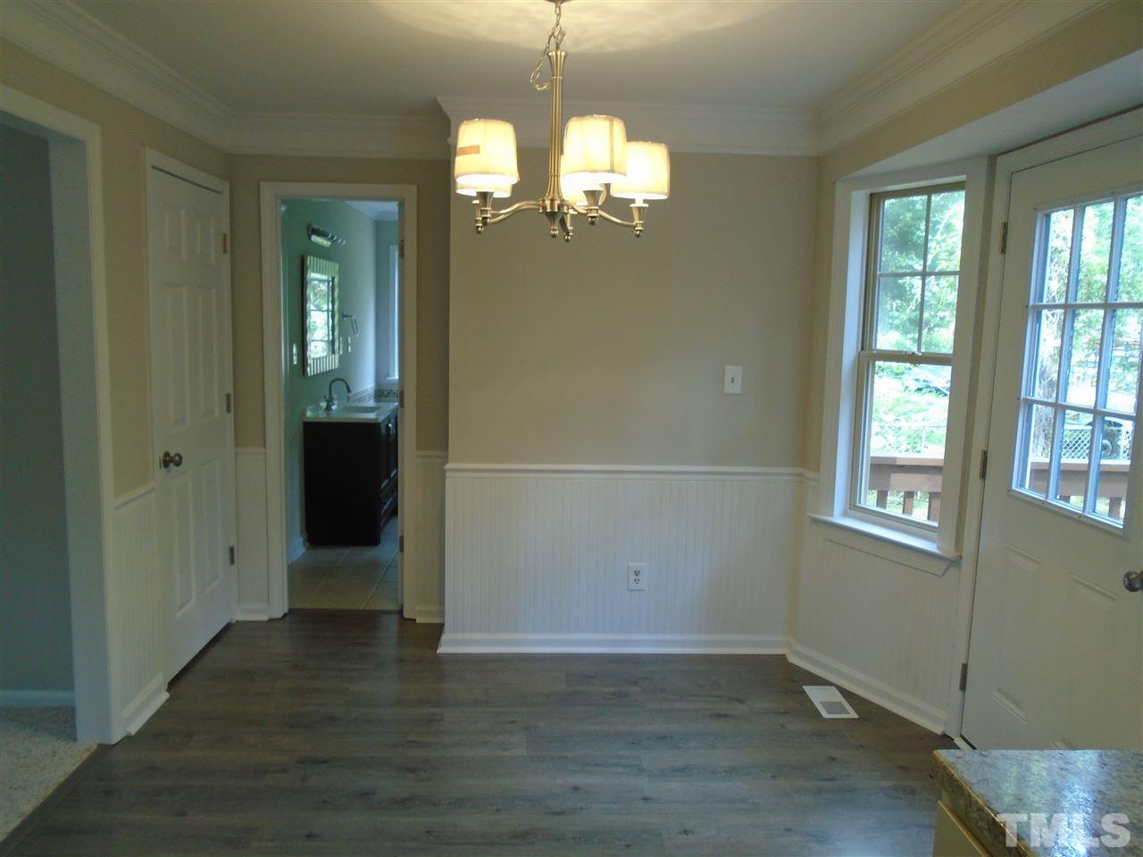 3241 Banks Road Raleigh, NC 27603 - Photo 8 of 19 an empty room with wooden floor and windows