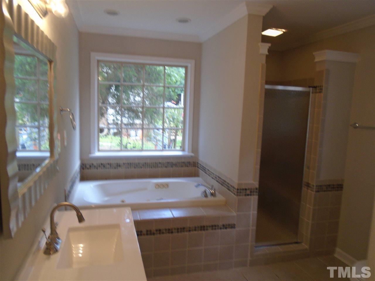 3241 Banks Road Raleigh, NC 27603 - Photo 10 of 19 a bathroom with a sink a bathtub and window
