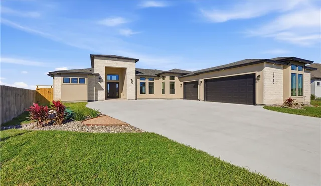 a view of an empty room with a window and a kitchen view