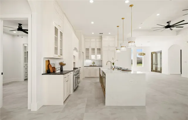 a kitchen with white cabinets and a sink