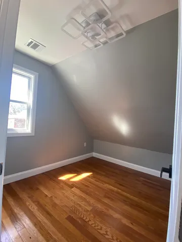 a bathroom with a sink a toilet a mirror and shower