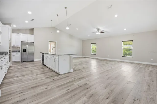 a view of a kitchen with cabinets and wooden floor