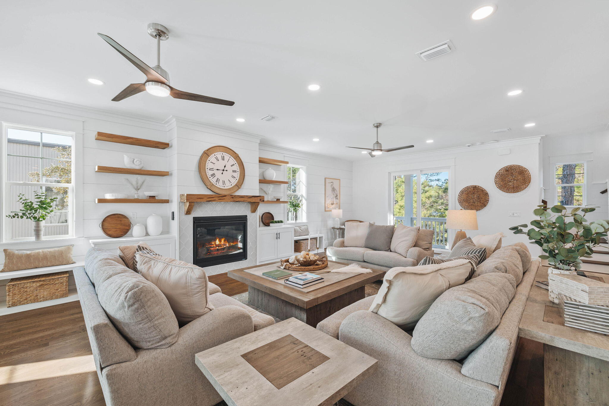 155 Grayton Boulevard Santa Rosa Beach, FL 32459 - Photo 5 of 36 a living room with furniture a fireplace and a chandelier