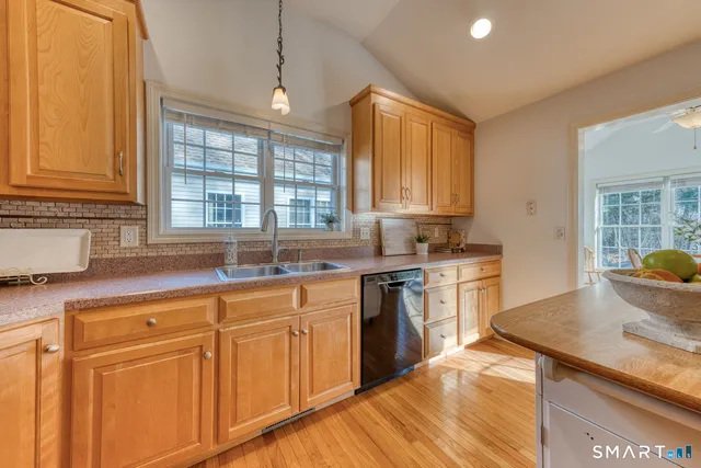 a kitchen with granite countertop white cabinets and white appliances