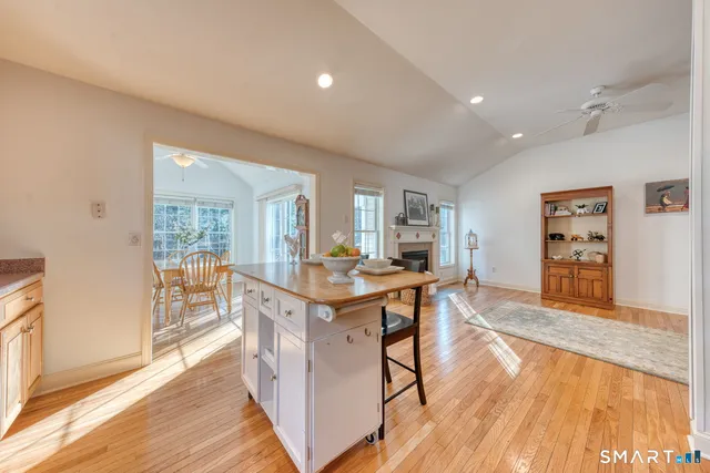 a open kitchen with stainless steel appliances granite countertop a stove and a wooden floors