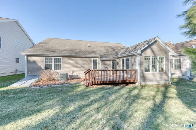a view of a house with a big yard and large tree