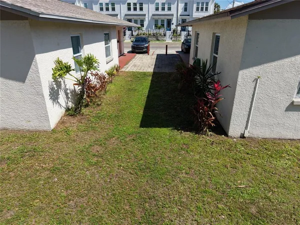 a backyard of a house with potted plants
