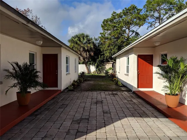 a vase of flowers sitting on a floor