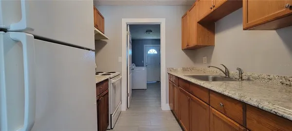 a kitchen with a sink and a refrigerator