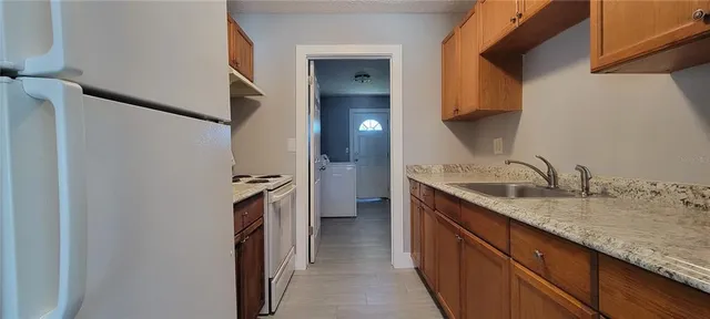 a kitchen with a sink and a refrigerator
