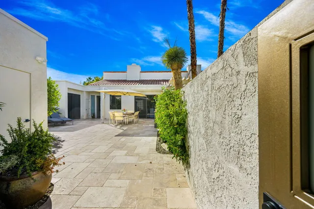a view of a house with backyard and sitting area