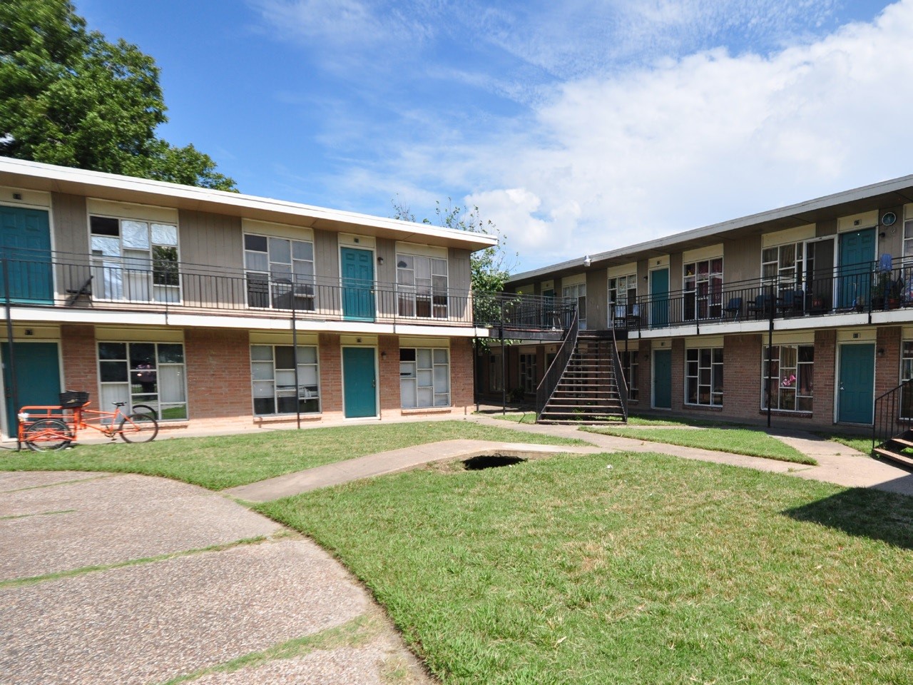 8445 Winkler Drive, Unit 11 Houston, TX 77017 - Photo 2 of 6 a front view of a house with a yard table and chairs