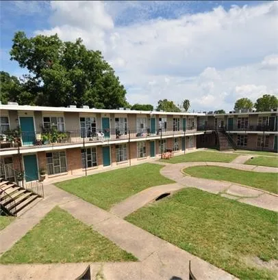 a view of a house with a big yard and large trees