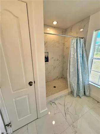 a bathroom with a shower and a glass door
