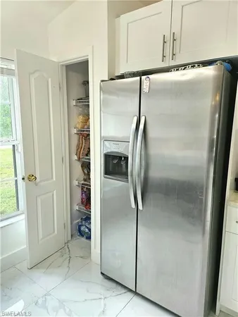 a view of an empty room with a fireplace and a large window