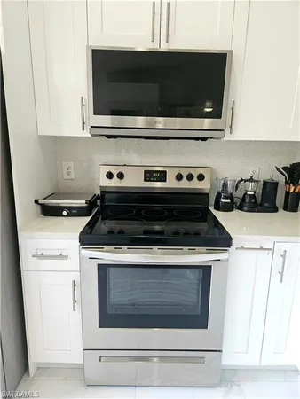 a stove top oven sitting inside of a kitchen