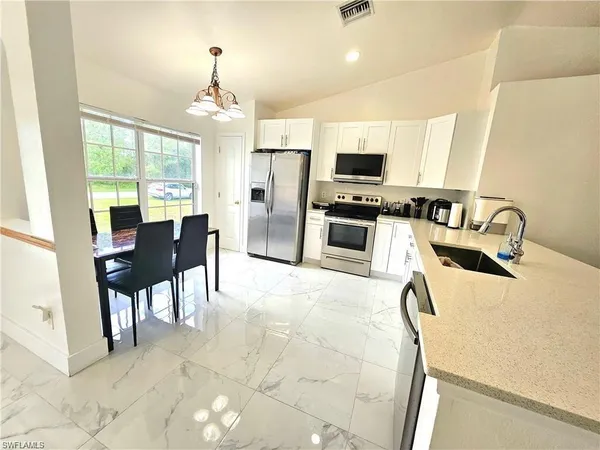 a dining room with furniture and chandelier
