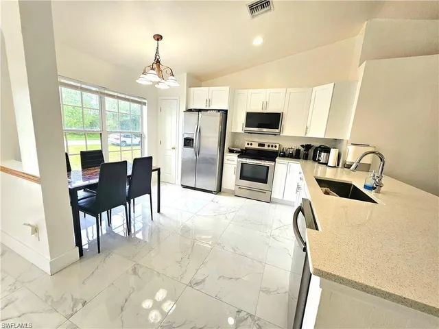 a dining room with furniture and chandelier