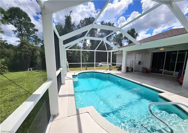 a view of a house with a backyard