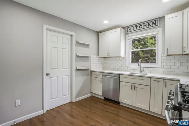 a kitchen with a sink cabinets and window