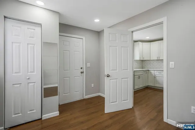 a view of a room with wooden floor and closet