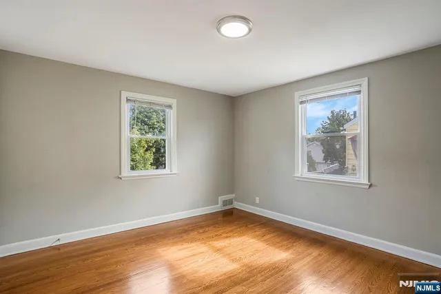 a view of room with hardwood floor and cabinet