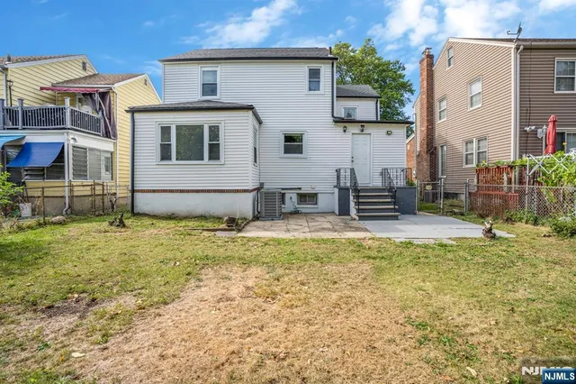 a backyard of a house with table and chairs