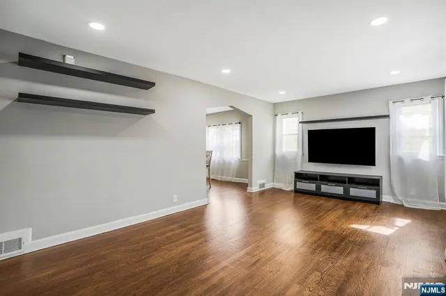 a view of a livingroom with furniture and a flat screen tv