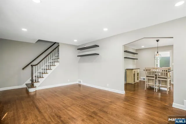 a view of dining room with wooden floor and a floor to ceiling window