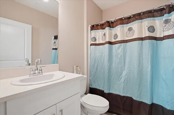 a bathroom with a toilet a sink and a mirror