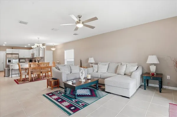 a living room with furniture and a chandelier