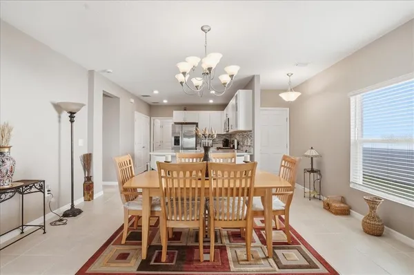 a view of a dining room with furniture and a chandelier
