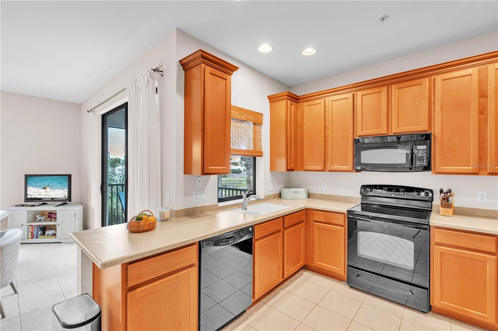 7250 Hamilton Road, Unit 7250 Bradenton, FL 34209 - Photo 11 of 34 a kitchen with stainless steel appliances granite countertop a sink stove and refrigerator