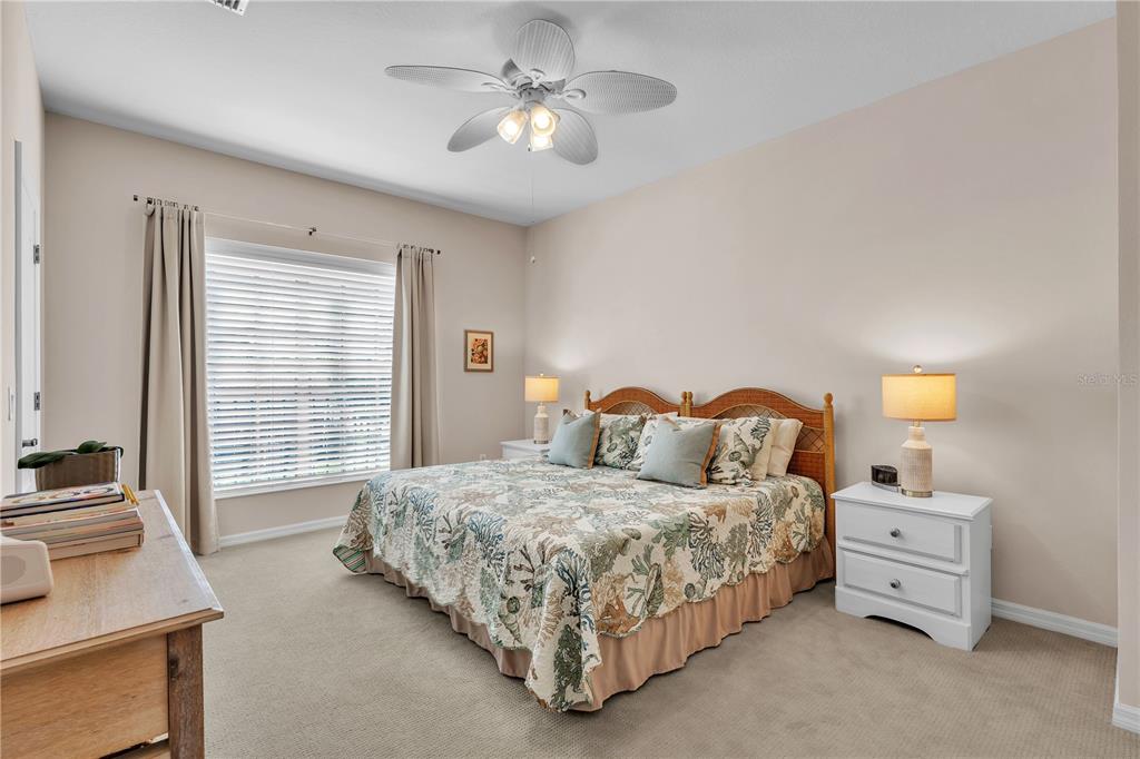 7250 Hamilton Road, Unit 7250 Bradenton, FL 34209 - Photo 18 of 34 a bedroom with a bed and a chandelier