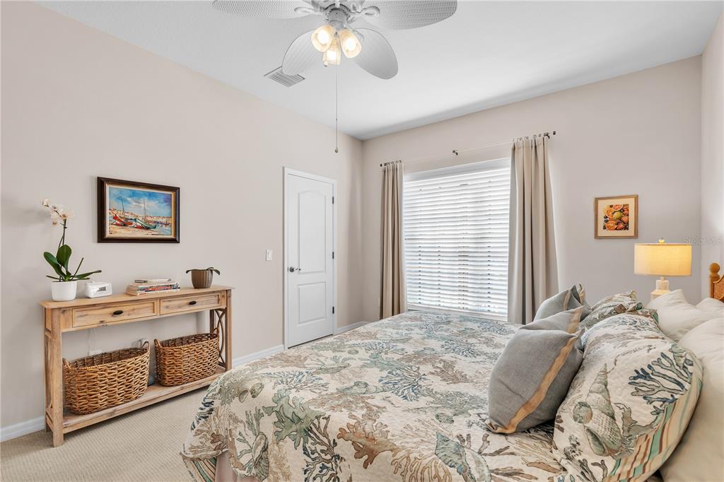 7250 Hamilton Road, Unit 7250 Bradenton, FL 34209 - Photo 20 of 34 a bedroom with a bed and a chandelier