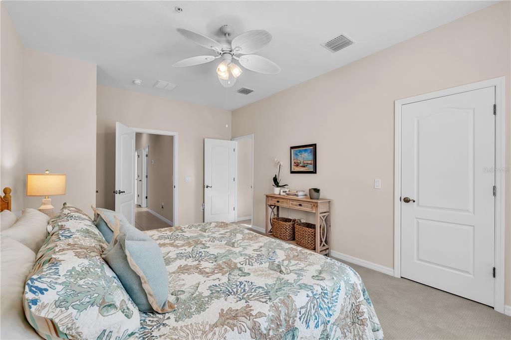 7250 Hamilton Road, Unit 7250 Bradenton, FL 34209 - Photo 21 of 34 a bedroom with a large bed and a chandelier
