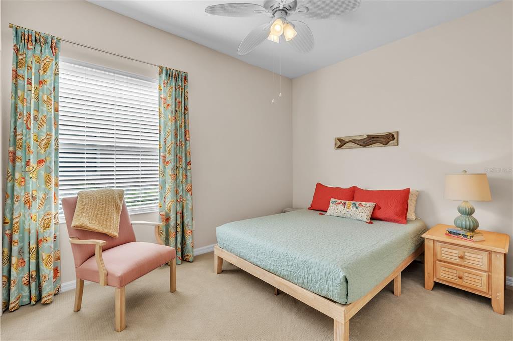 7250 Hamilton Road, Unit 7250 Bradenton, FL 34209 - Photo 23 of 34 a bedroom with a bed and a chair