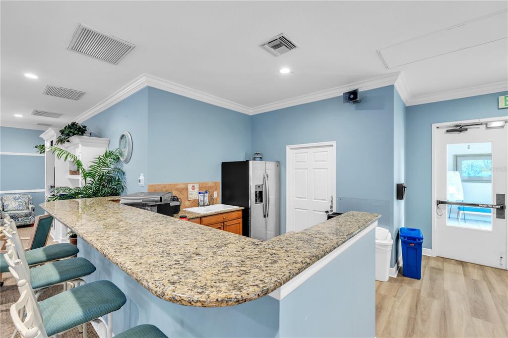 7250 Hamilton Road, Unit 7250 Bradenton, FL 34209 - Photo 31 of 34 a kitchen with granite countertop a counter top space and living room