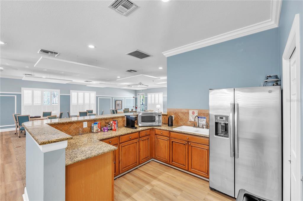 7250 Hamilton Road, Unit 7250 Bradenton, FL 34209 - Photo 32 of 34 a kitchen with stainless steel appliances granite countertop a sink a stove a refrigerator and island
