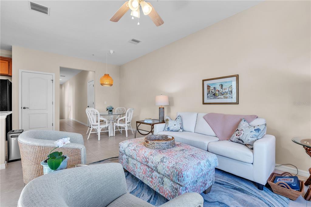 7250 Hamilton Road, Unit 7250 Bradenton, FL 34209 - Photo 6 of 34 a living room with furniture and a chandelier
